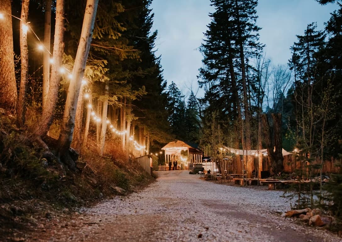 A string-lit path leading into Blackstone Rivers Ranch in the evening.