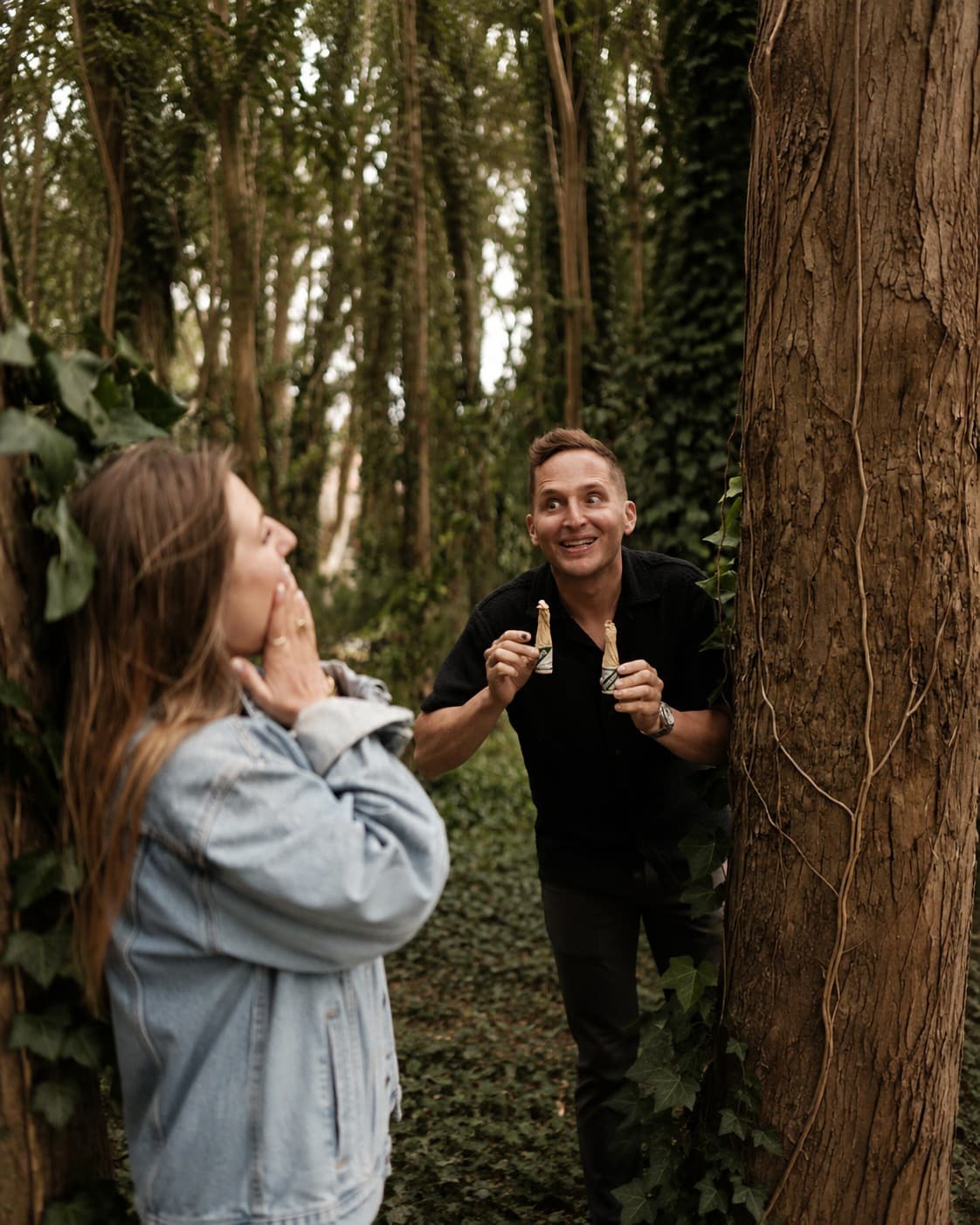 Thomas surprises Victoria with a miniature champagne bottle in the woods.